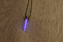 Load image into Gallery viewer, Tritium glow in the dark bright purple necklace with a steam punk coloured cap and brass ball chain.